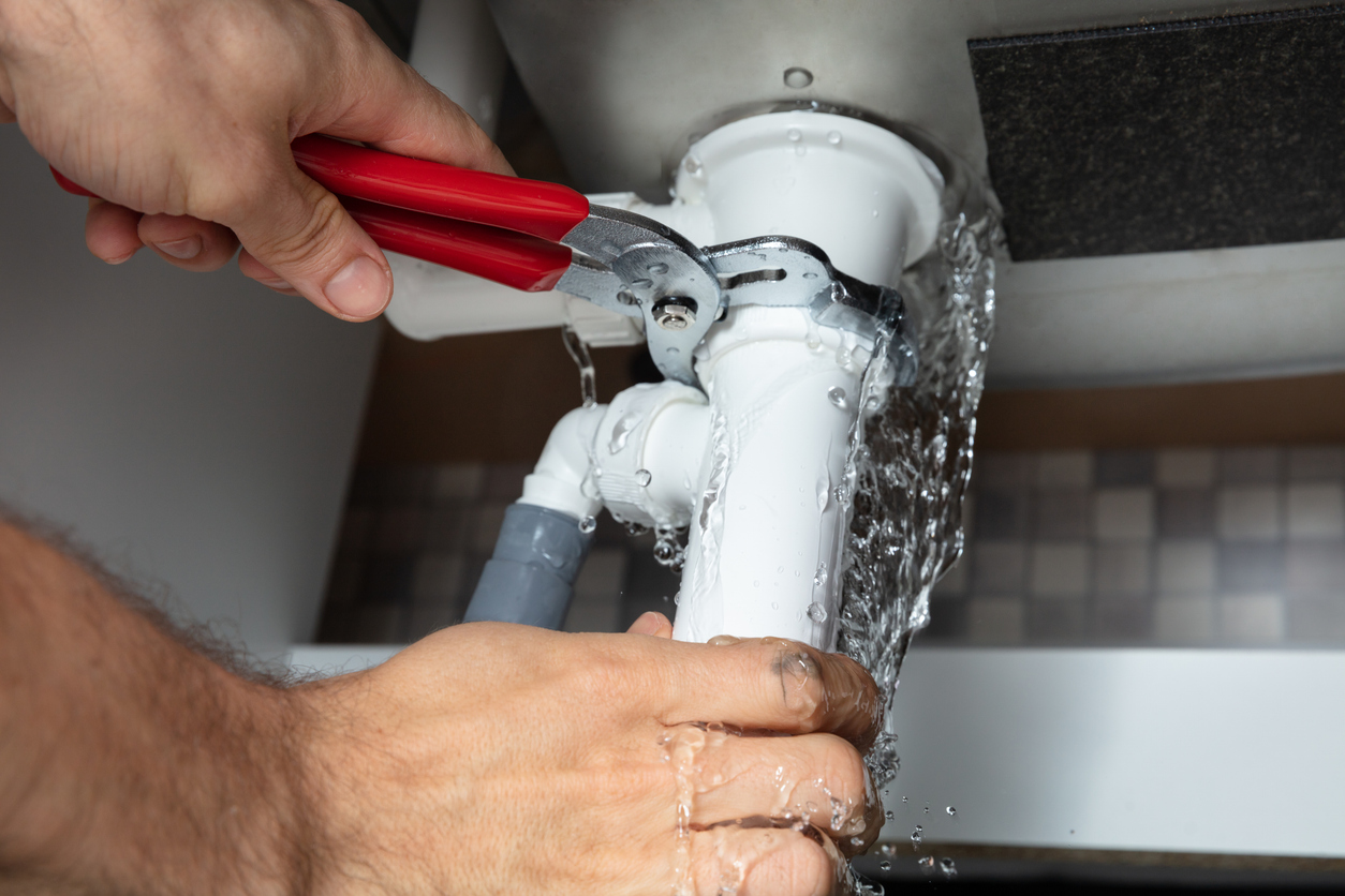 Plumber Fixing Sink Pipe