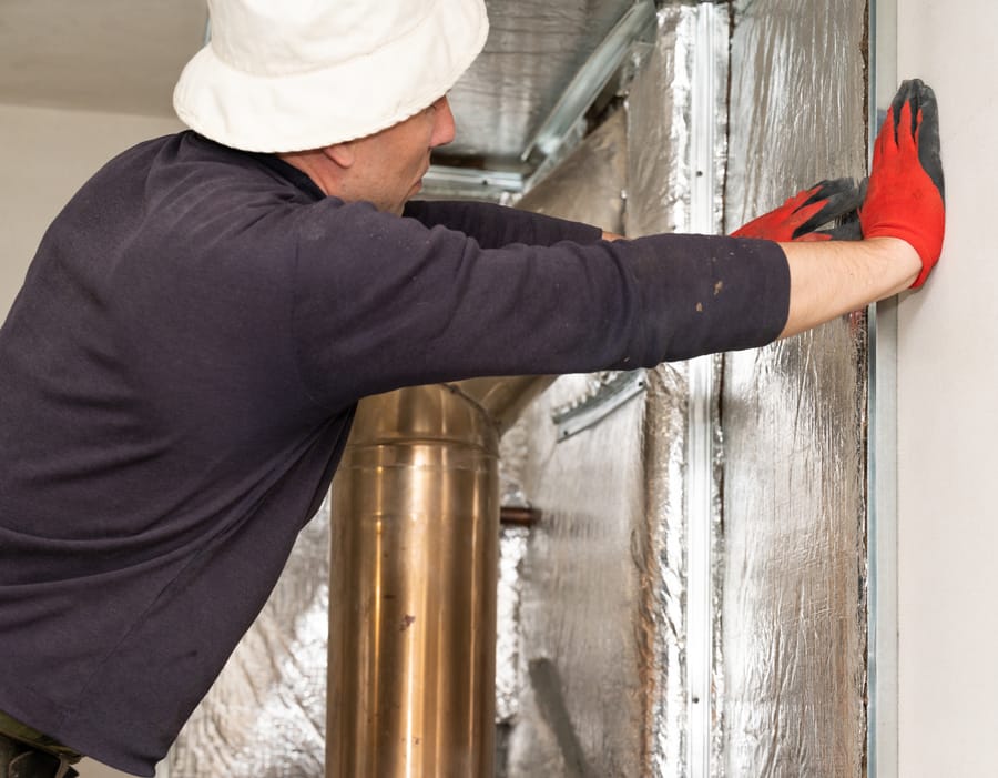 Technician working on interior chimney flue in Massapequa, NY to improve safety and efficiency