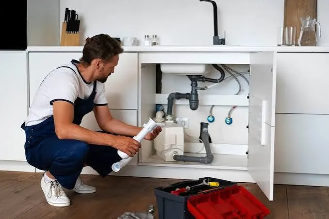 Kitchen faucet and water supply connections being inspected in Bellmore, NY.