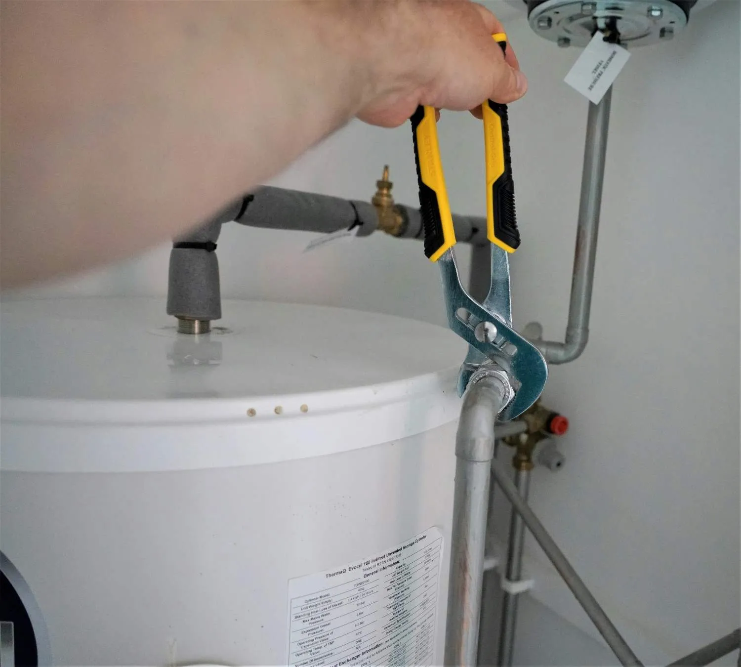 Shower valve and control components being checked in a Merrick, NY bathroom.