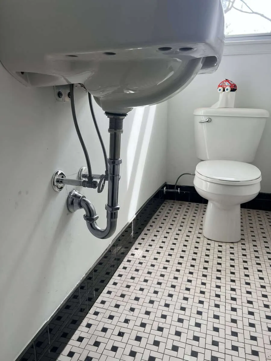 Under-sink supply lines, drain connections, and valves being checked in Dix Hills, NY. Plumber near me
